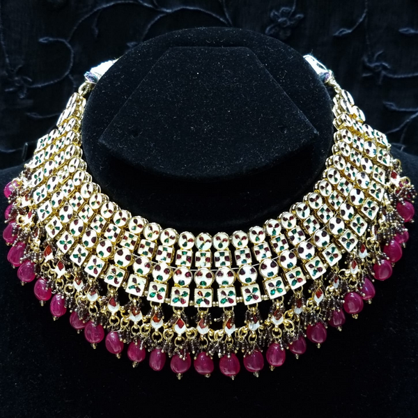 Bridal kundan piece is four layered set with dangling emeralds to match your festive.